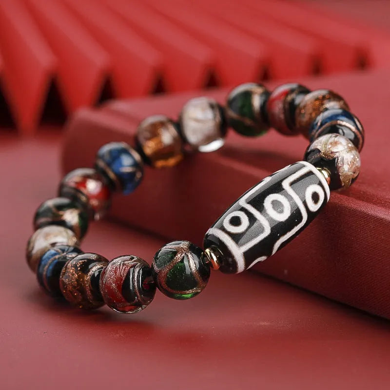 Close-up of a Chinese style coloured glaze bead bracelet with auspicious patterns, showing bead sizing options.