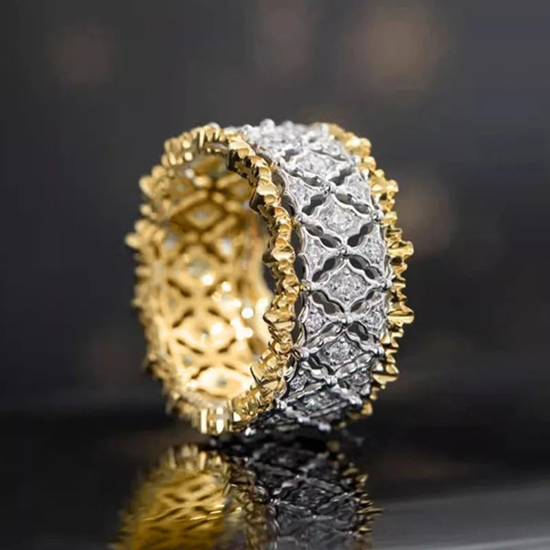 Gold and silver two-tone geometric ring with a central round zircon stone on a copper band.