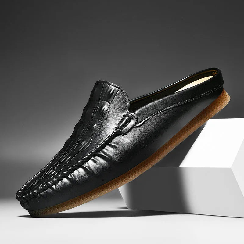 Men's black breathable Gommino semi-slippers with a rubber sole on a plain background