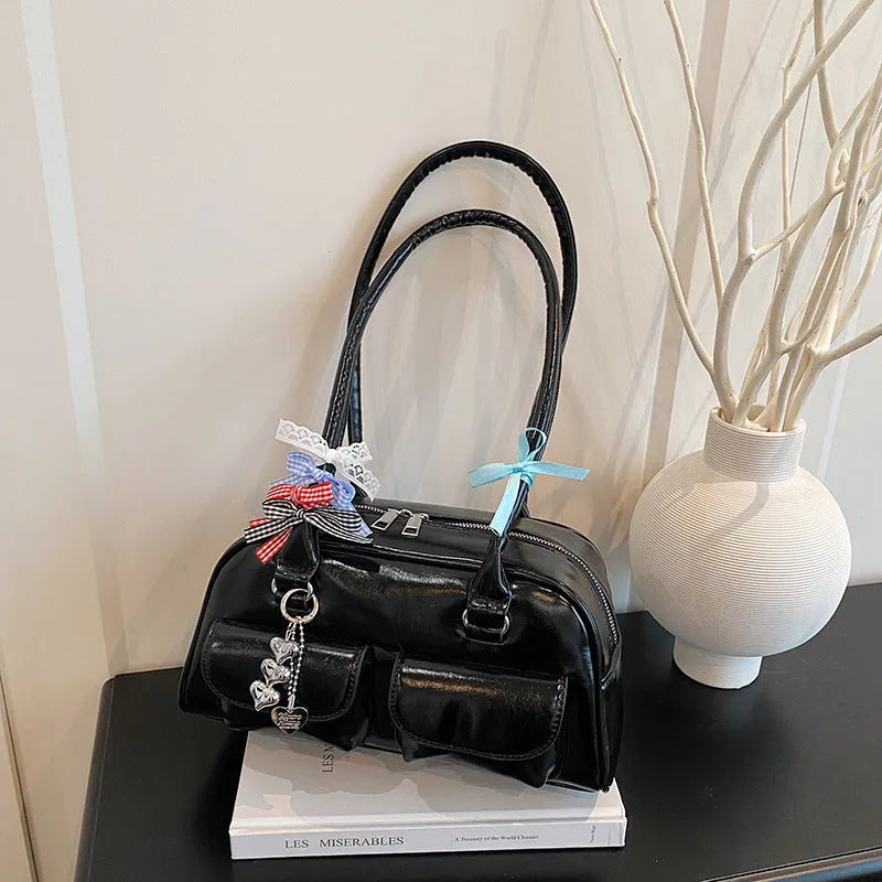 Retro style women's PU leather pillow-shaped flap handbag in black, shown with a double shoulder strap.