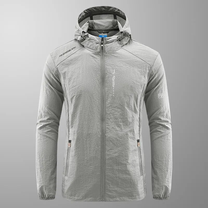 Man wearing a lightweight light grey hooded summer jacket made of thin nylon.