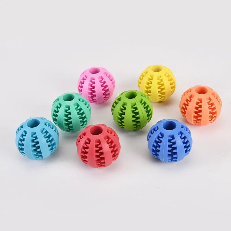 Small pink rubber pet dog toy self-hi relieving stuffy molars chew toy 5cm diameter on white background