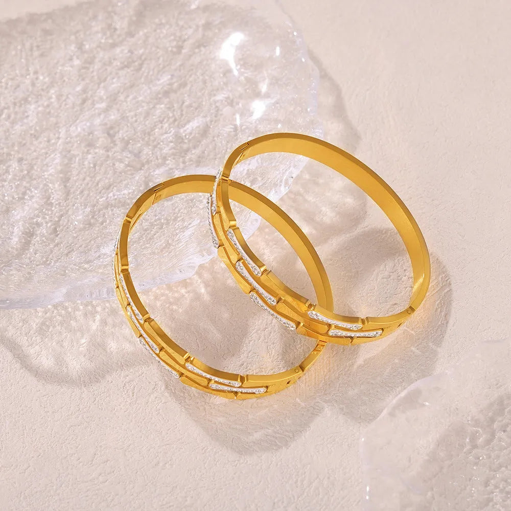 Gold electroplated titanium steel hollow splicing casual bracelet for women, open cuff design on white background