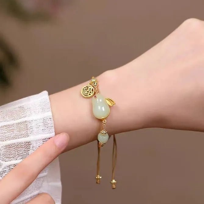 Hetian jade rabbit charm bracelet on yellow string with geometric shape