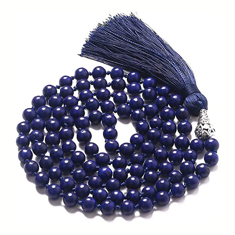 Long agate tassel necklace with geometric beads in multiple natural stone colours on a white background.