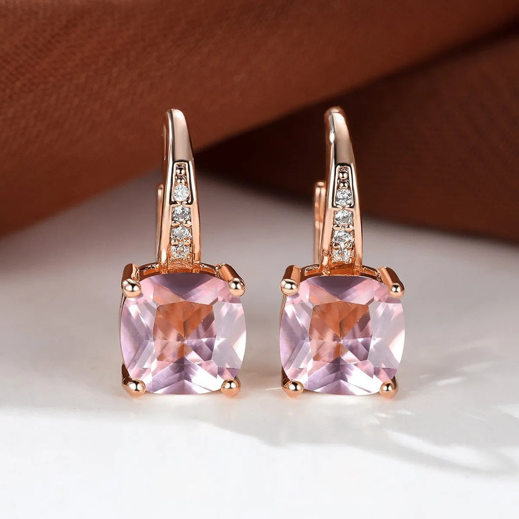 Geometric copper ear hook earrings with a round square zircon inlay, shown in a gold electroplated finish.