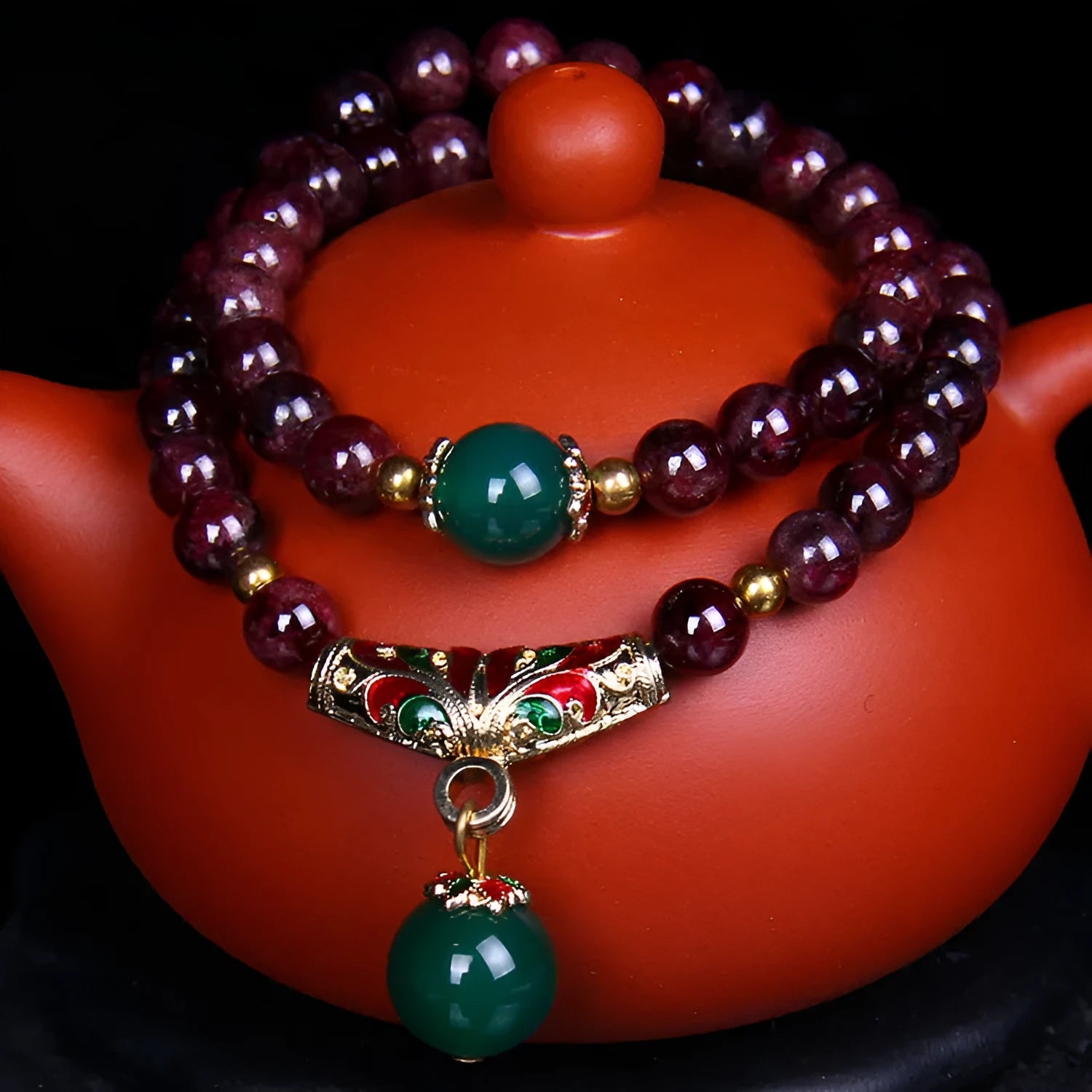 Natural garnet bracelet with 7mm beads, double gold ring clasp, and golden toad charm.