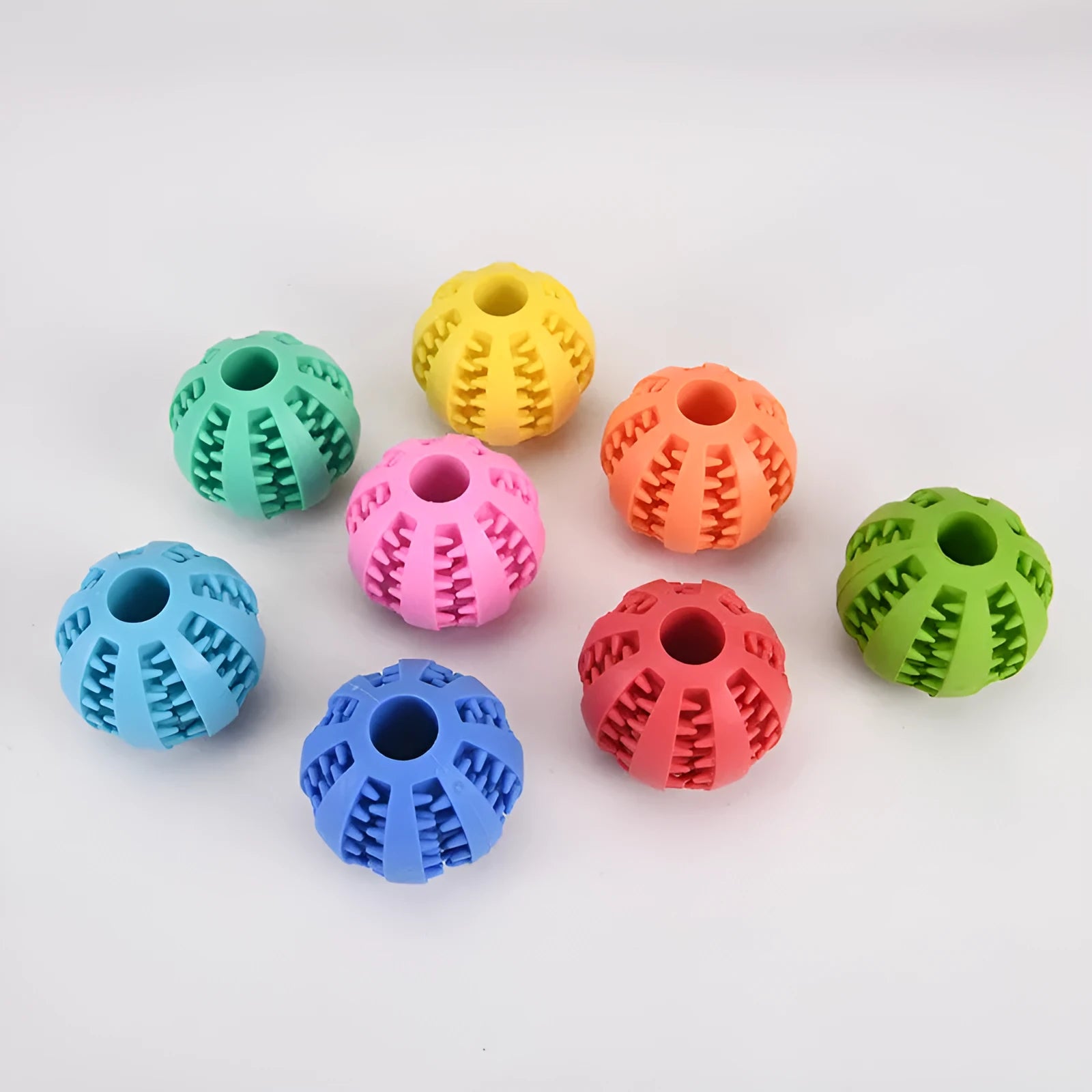 Small pink rubber pet dog toy self-hi relieving stuffy molars chew toy 5cm diameter on white background