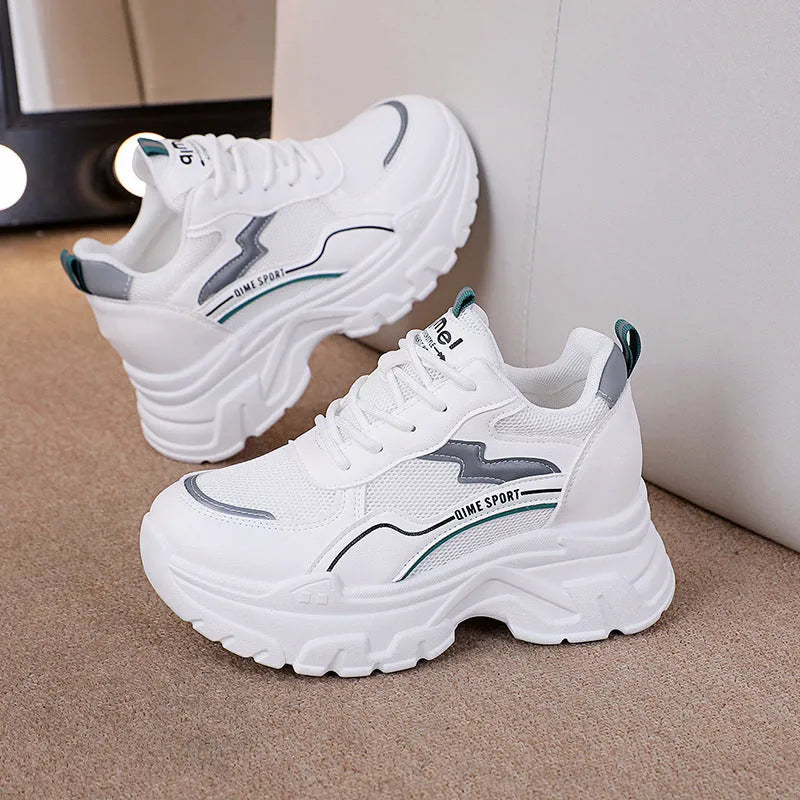 Women's white low-top sports dad shoes with cross strap and round toe, showcasing breathable mesh design.