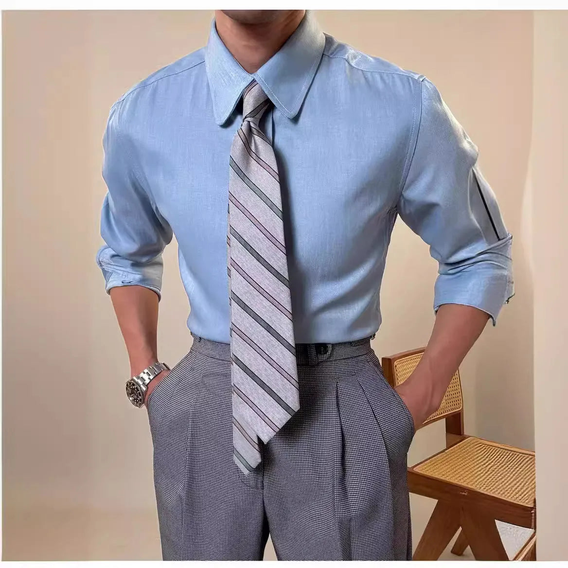 Men's slim fit long sleeve round collar shirt in a light blue colour, showcasing the button front and cuff detail.