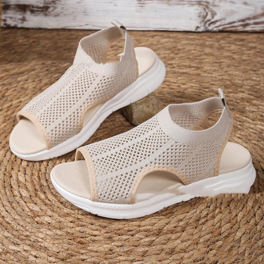 Women's flat platform sports sandals in black with a rubber sole and mesh lining.