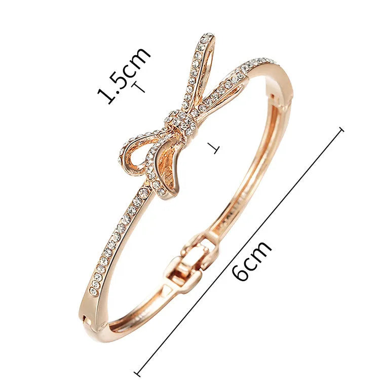 Rose gold electroplated copper women's bracelet with bow and diamond accents