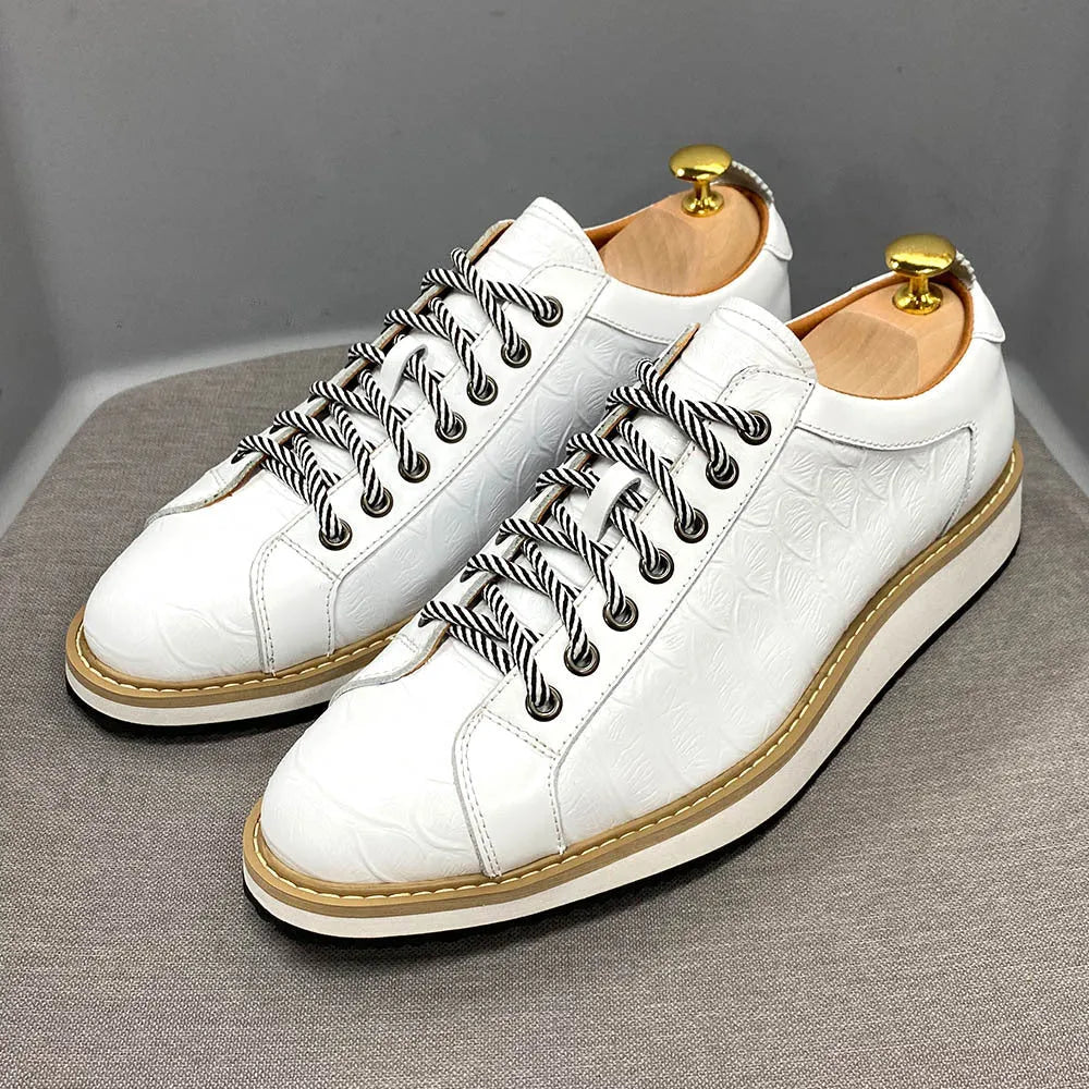 Men's handmade embossed pattern shoes in low tube design with front tie closure showing detail of pattern work