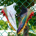 High-top soccer training shoes with gold bottom detail on artificial grass surface