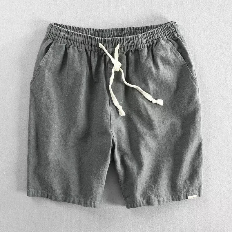 Man wearing loose-fitting cotton and linen casual shorts in a straight-leg style with an elasticated waist.