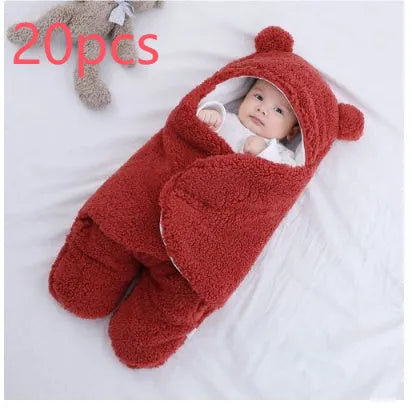 A baby quilted sleeping bag wrapper in a cotton blend fabric, shown in a light blue colour, laid flat.