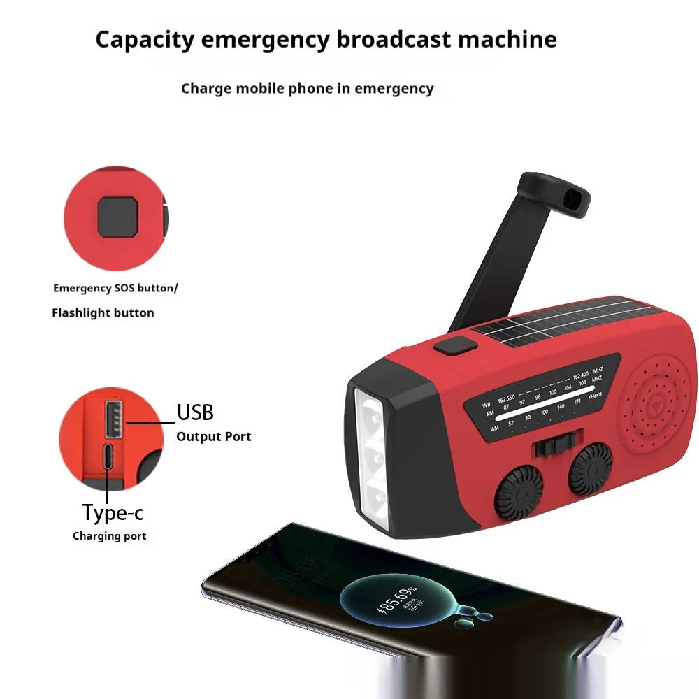 Red rechargeable emergency hand radio torch with USB port and wrist strap for disaster preparedness