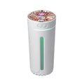 Black and white portable wireless humidifier with LED lights on a car cup holder and desktop