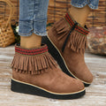 Women's suede ankle boot with wedge heel, side zipper, tassel detail, and thick rubber sole in three colour options.