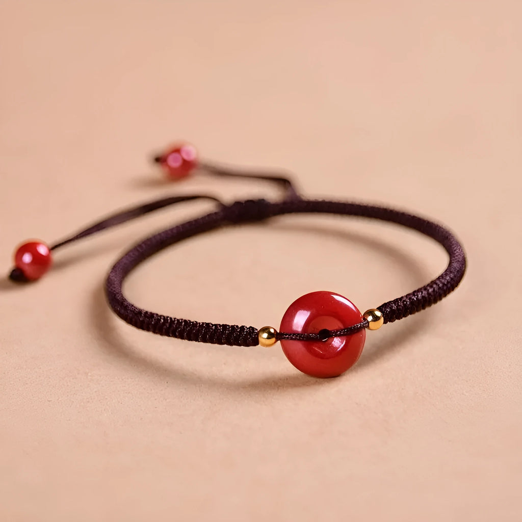Cinnabar safety buckle bracelet with heart-shaped beads on adjustable rope cord in traditional birth year design