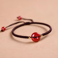 Cinnabar safety buckle bracelet with heart-shaped beads on adjustable rope cord in traditional birth year design