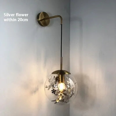 Modern glass wall-mounted bedside lamp in gold or silver finish, shown in 15cm and 20cm size options.