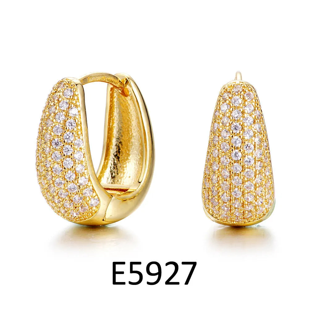Gold plated heart shape ear clip earrings with crystal accents on white background