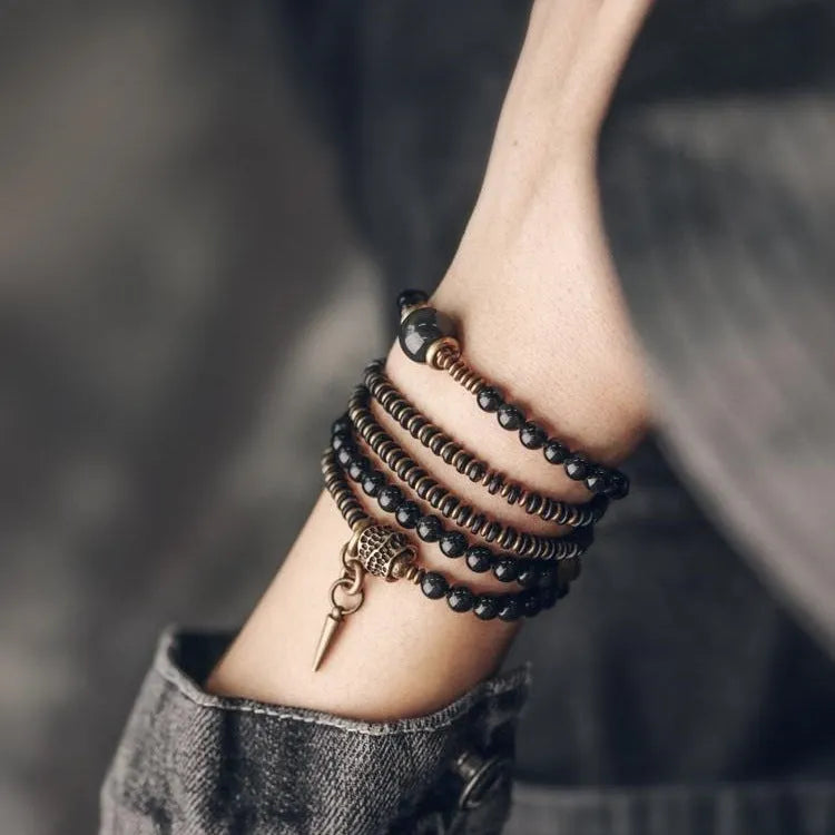 Black multi-layered beaded bracelet with geometric shapes and colourful retro patterns