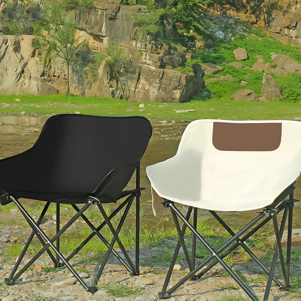 Beige portable folding camping chair with steel frame on grass outdoors