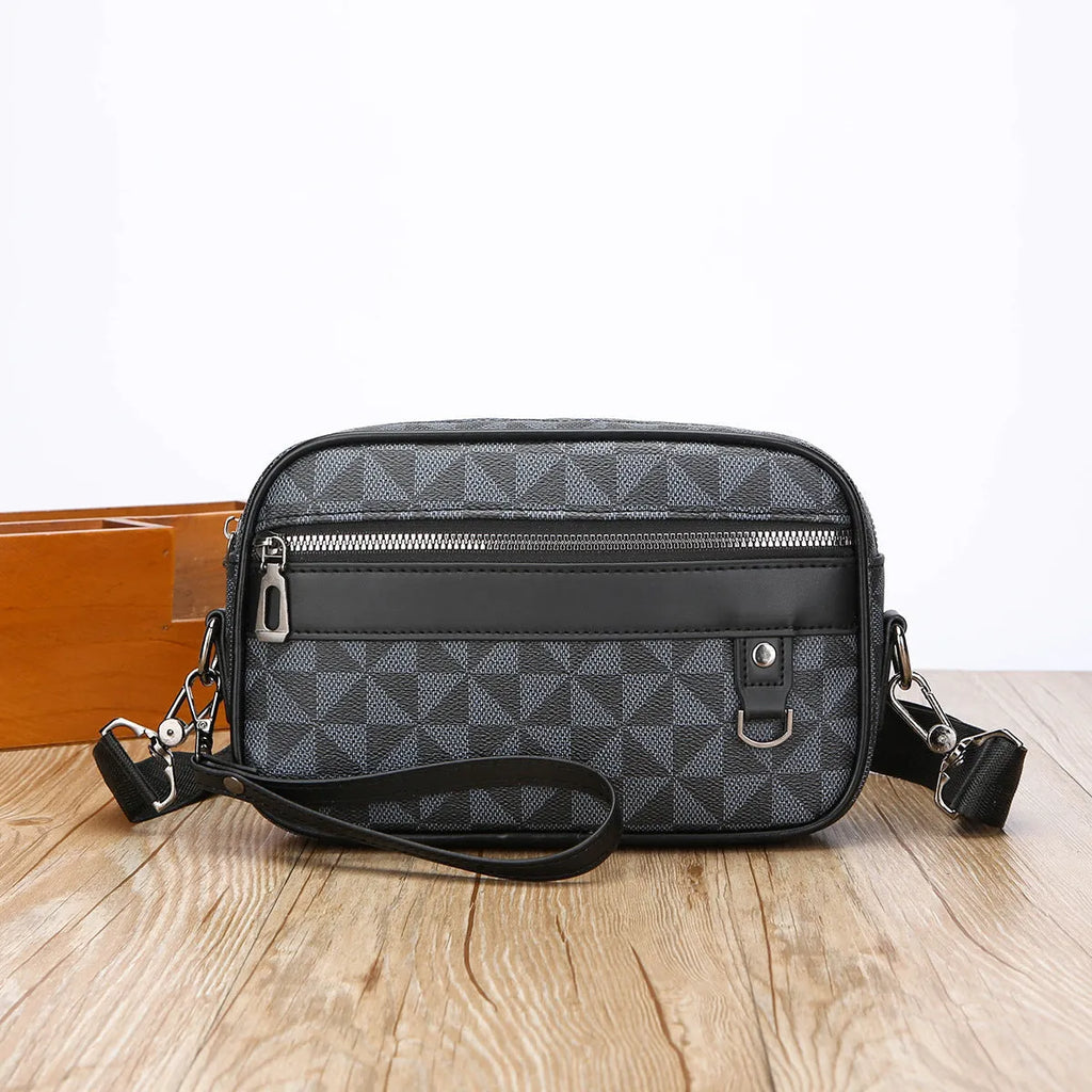Men's black PU leather messenger bag with geometric pattern, showing horizontal shoulder carry design