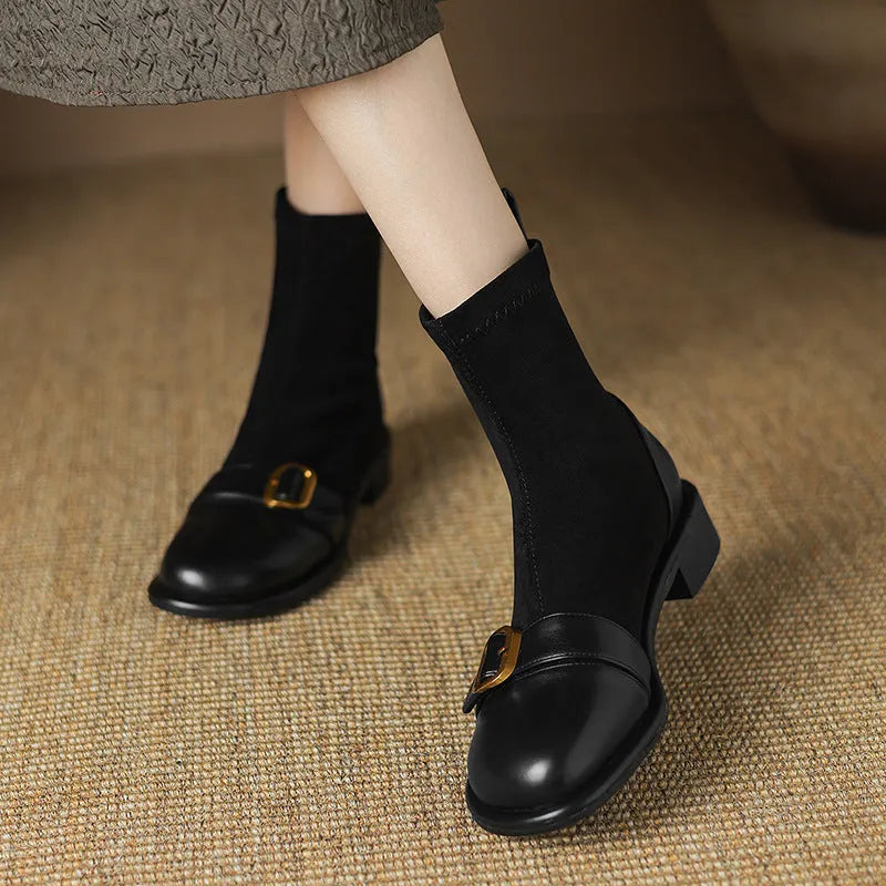 Women's black casual Martin ankle boots with belt buckle stitching and white laces on a rubber sole.