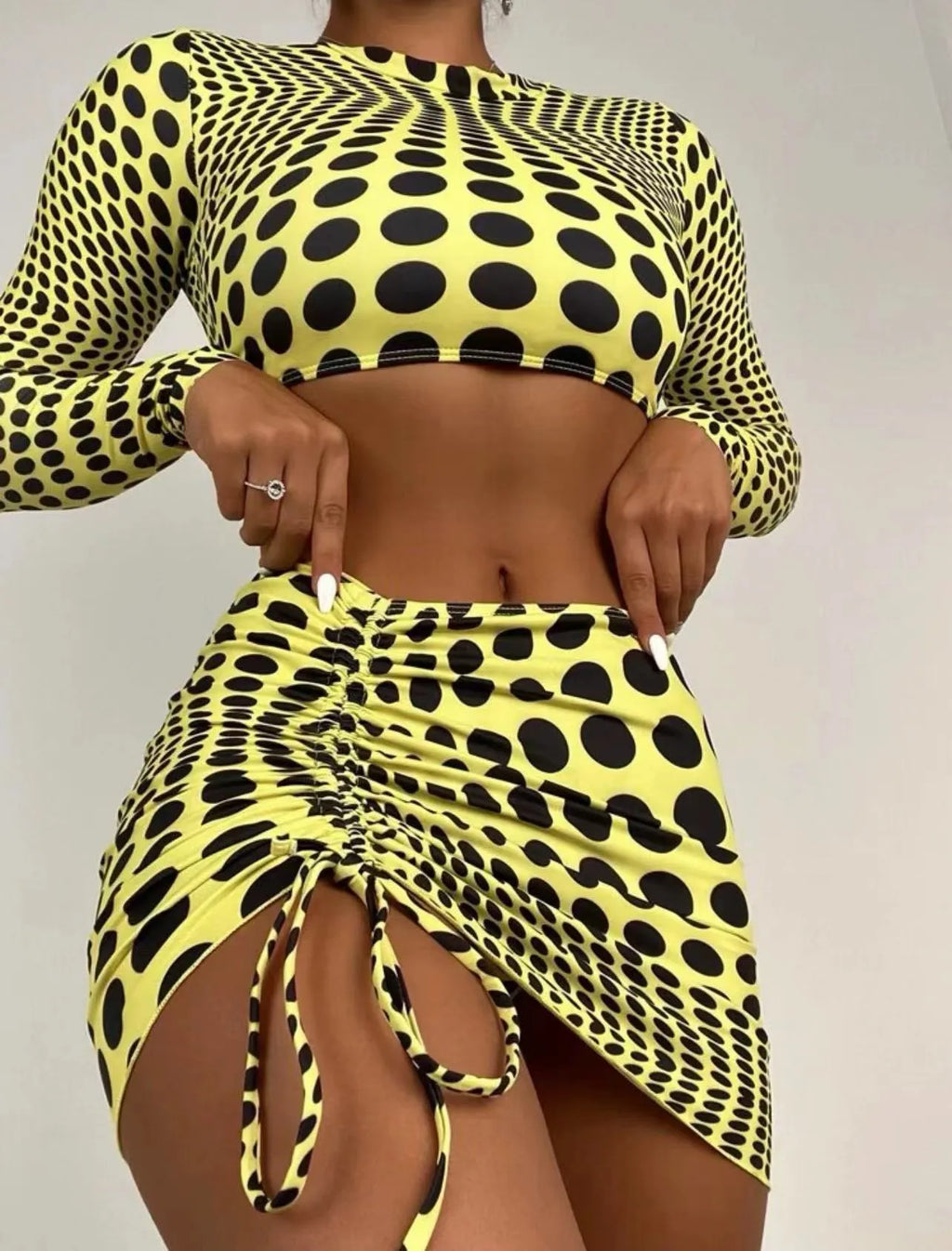 Women's green polka dot swimsuit three-piece set showing top, skirt, and bra