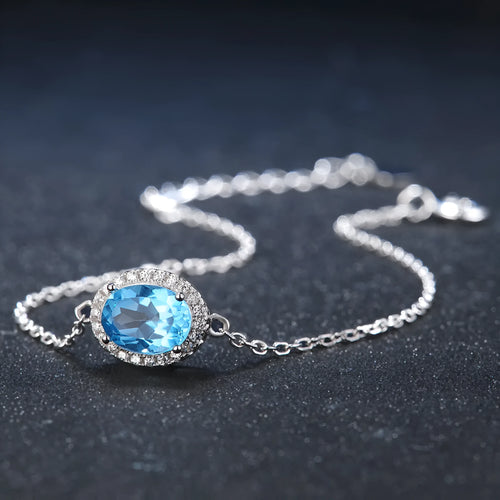 Geometric 925 sterling silver jewellery set with blue topaz stones, showing earrings, ring, pendant and necklace.