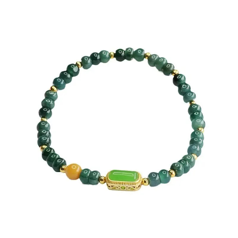 Natural stone blue water jade beaded bracelet with round and oval geometric beads on a white background