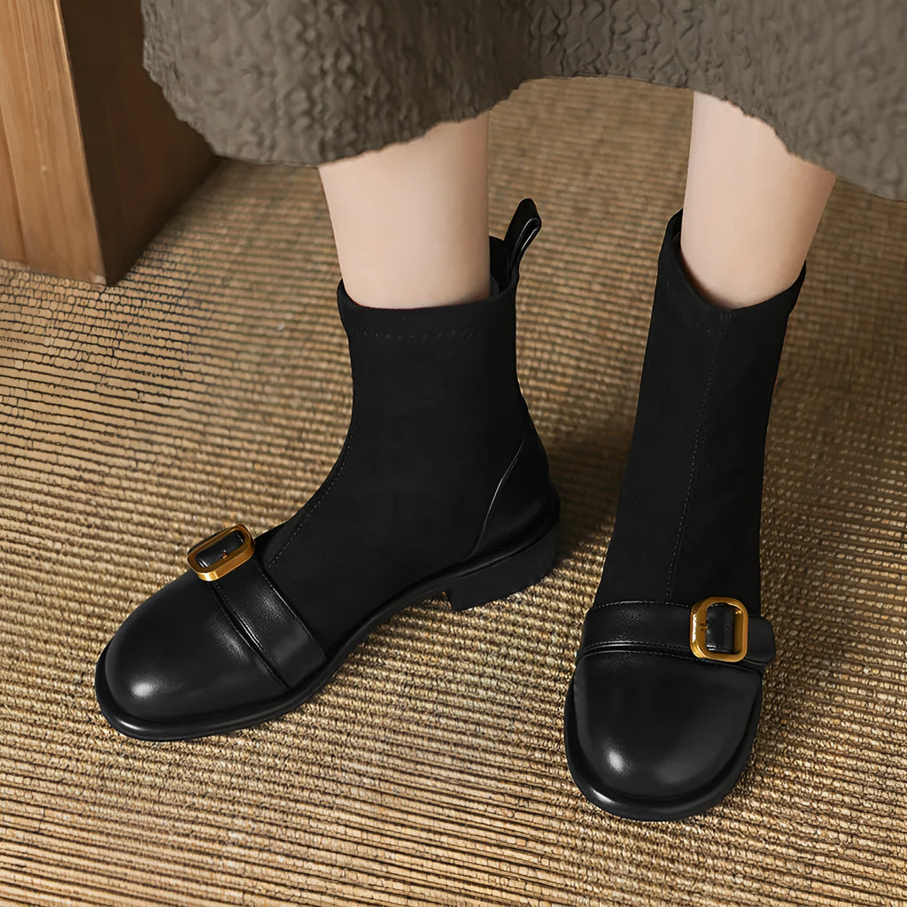 Women's black casual Martin ankle boots with belt buckle stitching and white laces on a rubber sole.