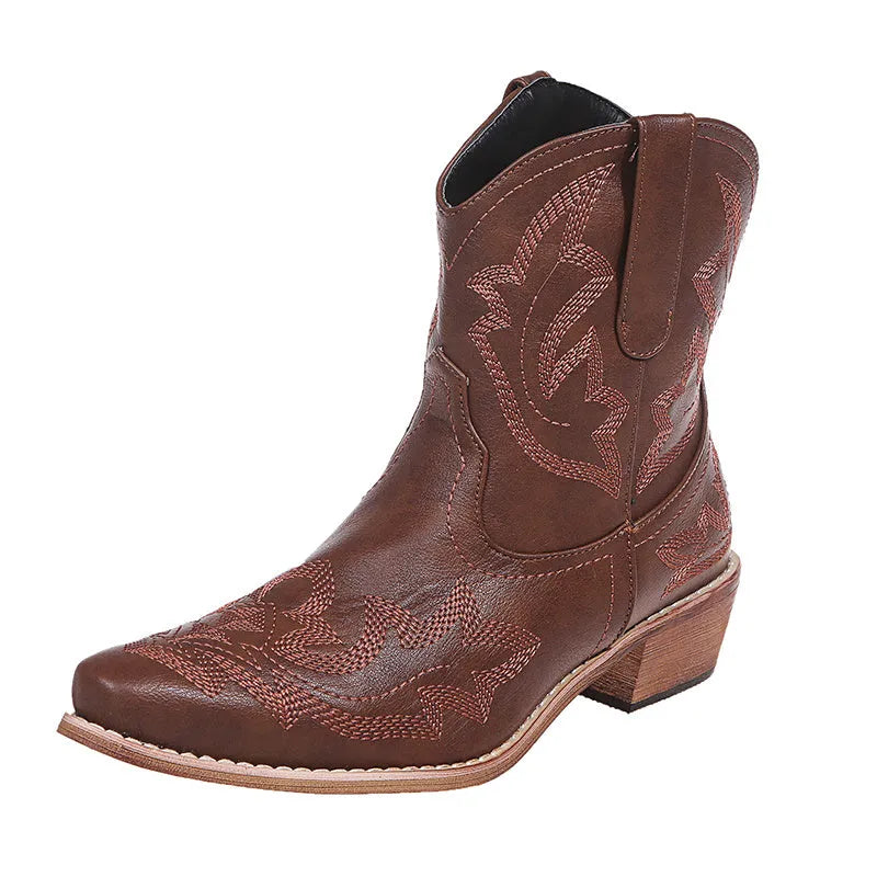 Women's brown cowboy boots with embroidery on the shaft, pointed toe, and a low wedge heel.