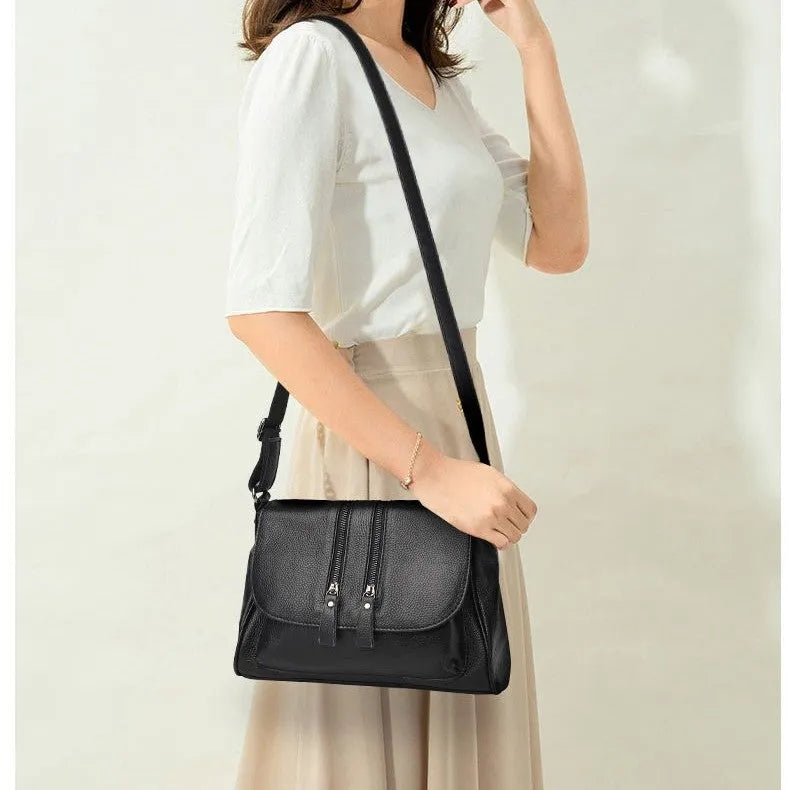 Cowhide leather shoulder handbag with chain and cover closure, 30x19x13cm, shown in wine red or light purple.