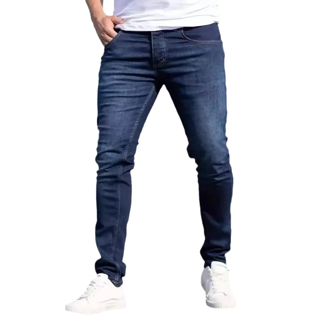Dark blue men's slim fit skinny jeans with zipper fly on mid waist