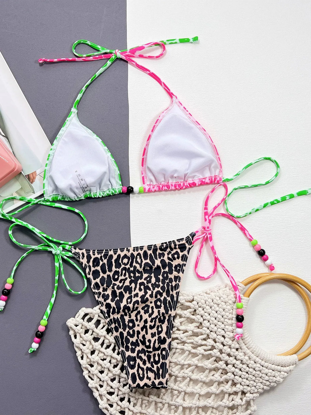 Women's leopard print bikini swimsuit set with bra and briefs on a white background.
