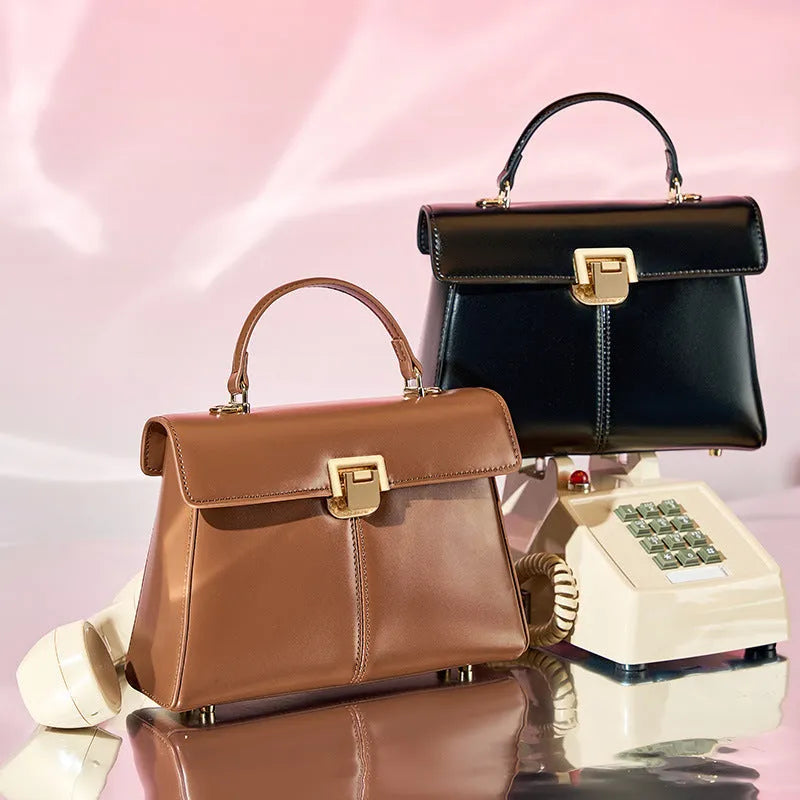 Women's black leather shoulder bag with vachette clasp and horizontal square shape