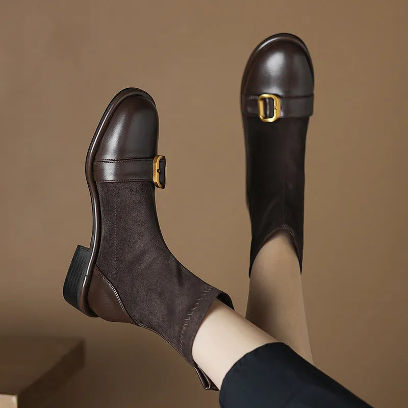 Women's black casual Martin ankle boots with belt buckle stitching and white laces on a rubber sole.