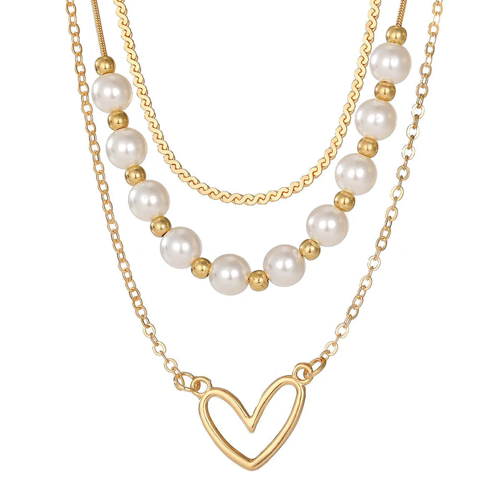 Vintage gold necklace with heart-shaped pendant on adjustable pearl-style chain