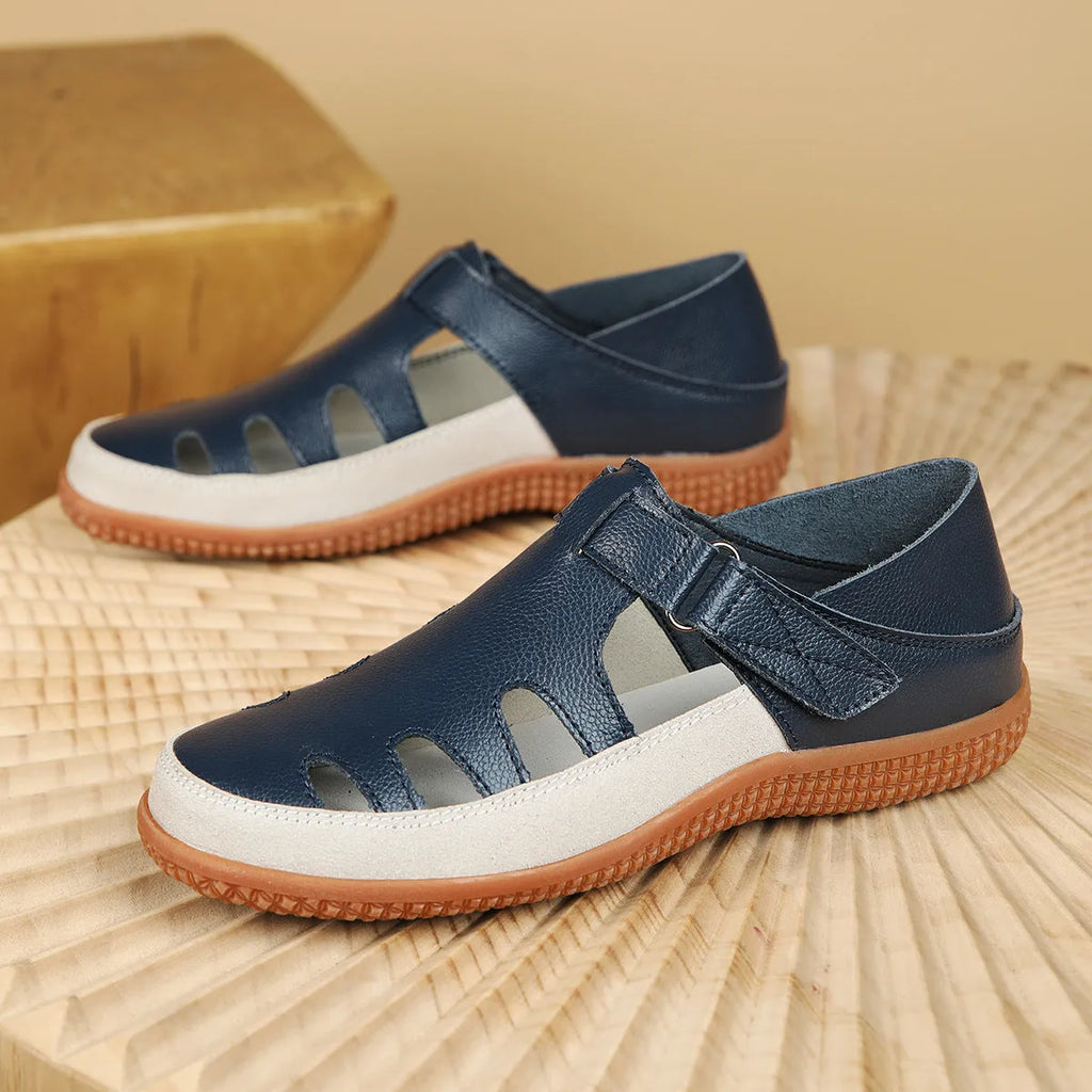 Women's plus size flat heel sandals with hollow out toe cap design in blue colour showing rubber sole