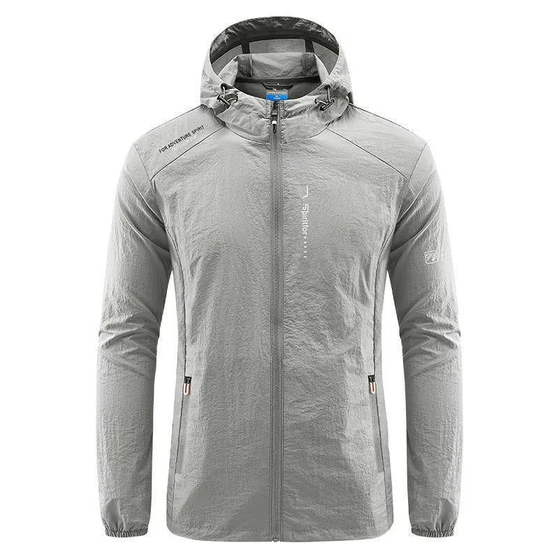 Man wearing a lightweight light grey hooded summer jacket made of thin nylon.