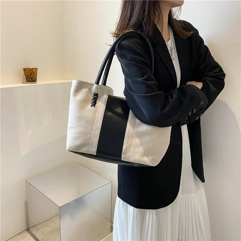 Women's large nylon tote bag in black with detachable shoulder strap, polyester lining, phone and document pockets