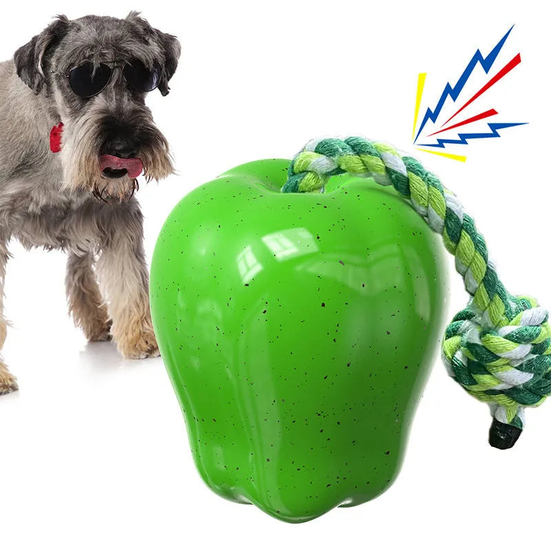Green apple-shaped plastic dog chew toy with hollow treat-dispensing design