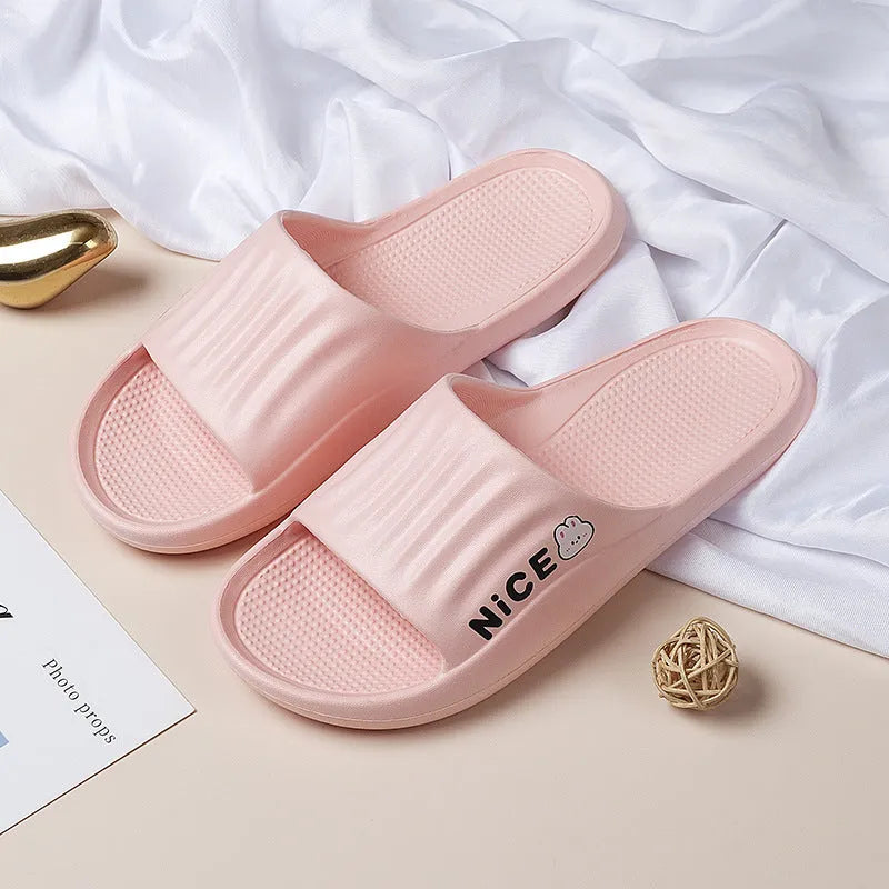Pair of lightweight EVA flip-flop slippers with a minimalist cartoon pattern and non-slip soles.