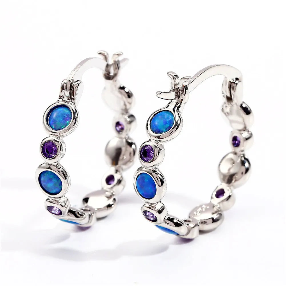Round copper earrings with synthetic opal and cubic zirconia in platinum white finish