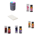 Mini white USB humidifier with 300ml tank and four 10ml essential oil bottles on a wooden table