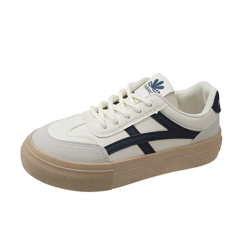 Blue low-top women's casual trainers with round toe and white rubber sole on a plain background.